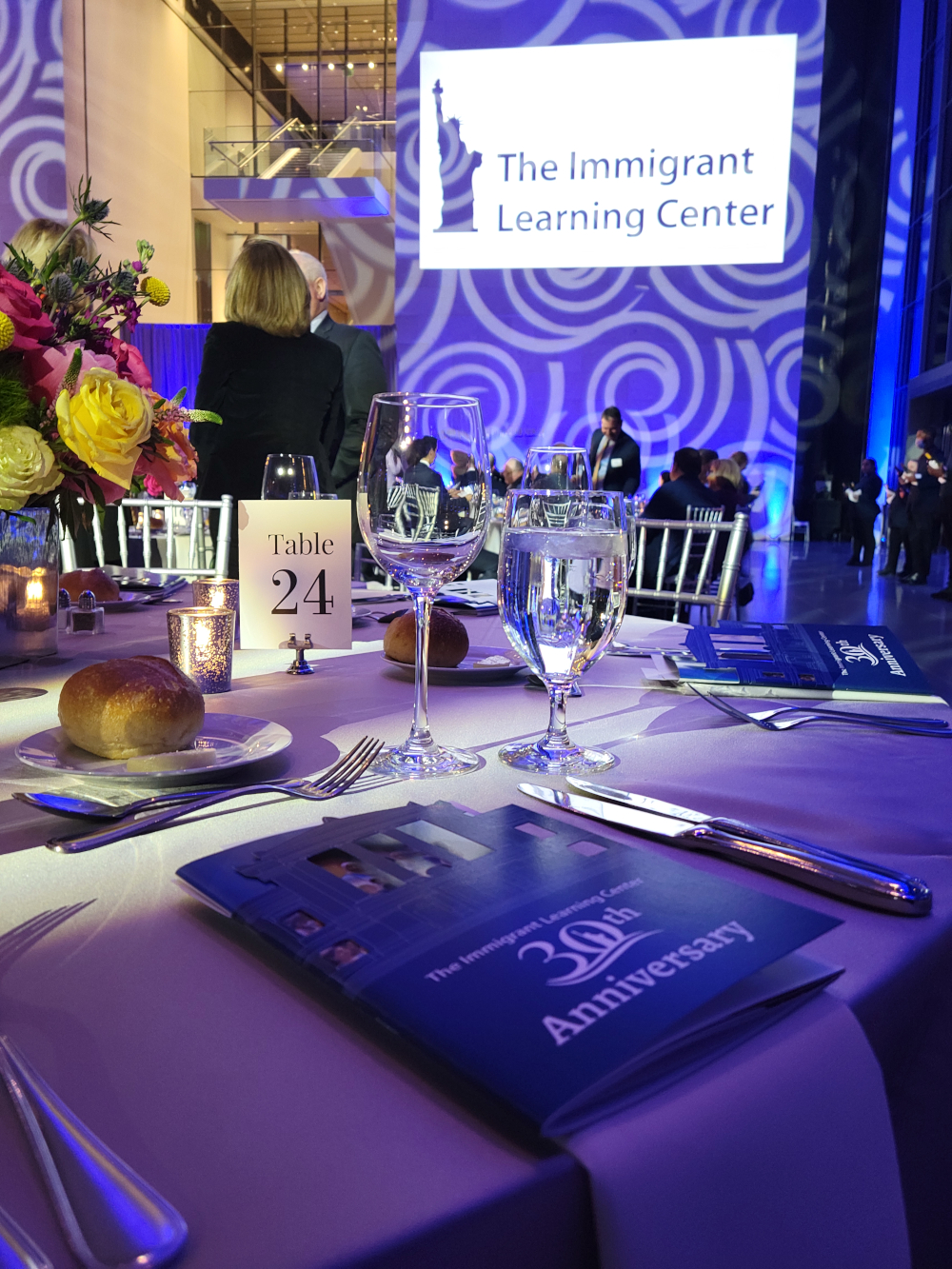 Photo from The Immigrant Learning Center's 30th Anniversary at the Museum of Fine Arts, showcasing the venue and program book.