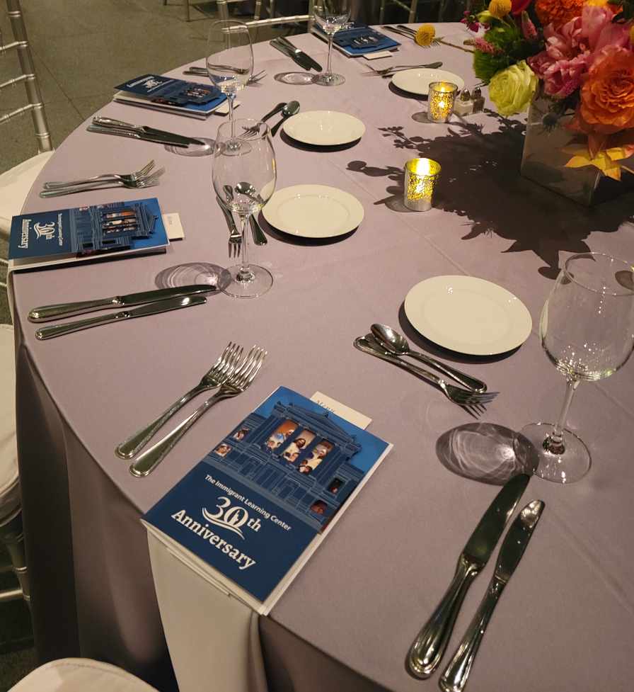 Photo from The Immigrant Learning Center's 30th Anniversary at the Museum of Fine Arts, showcasing how the program books were laid out on each table.